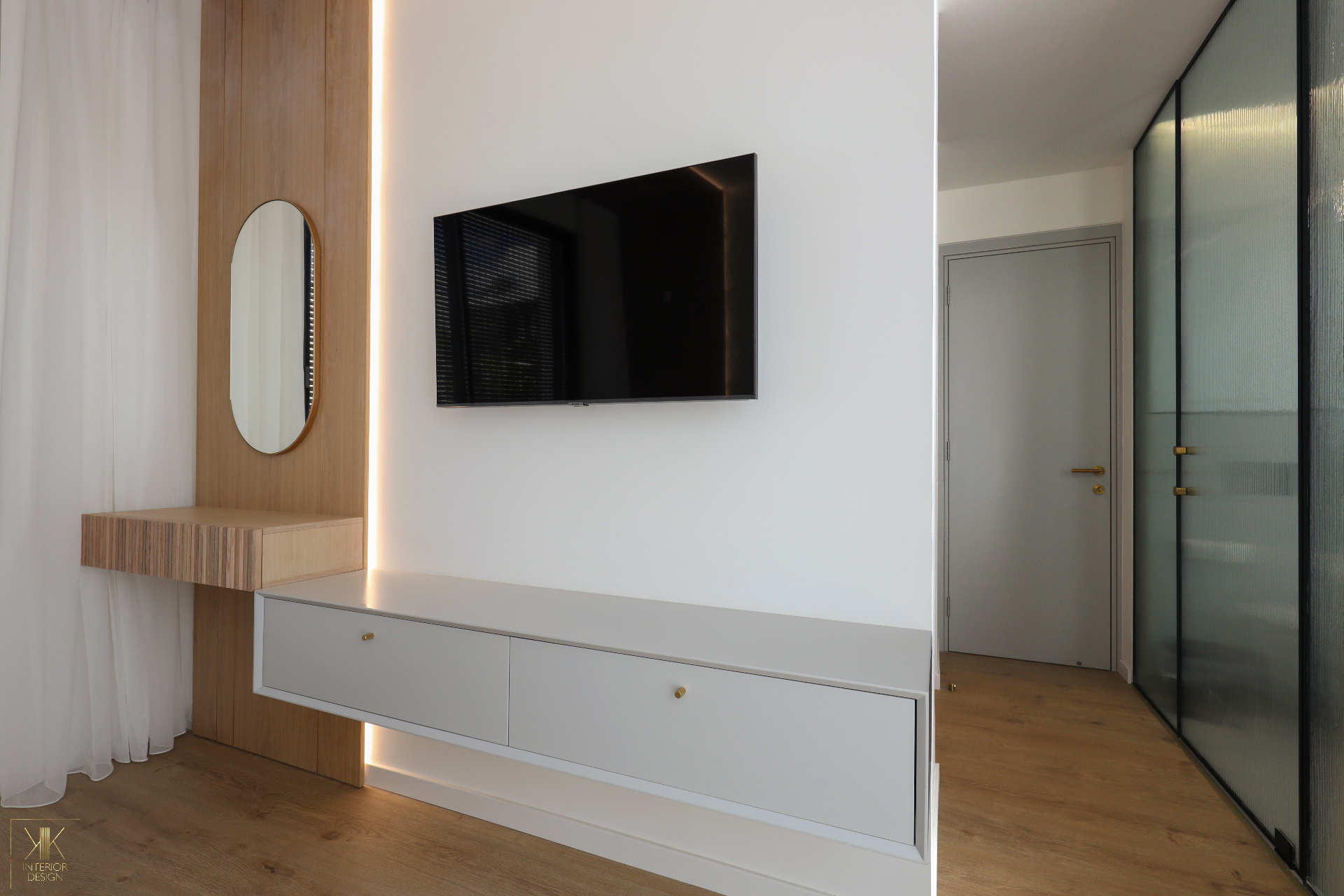 Bedroom media wall in oak panelling with floating drawers