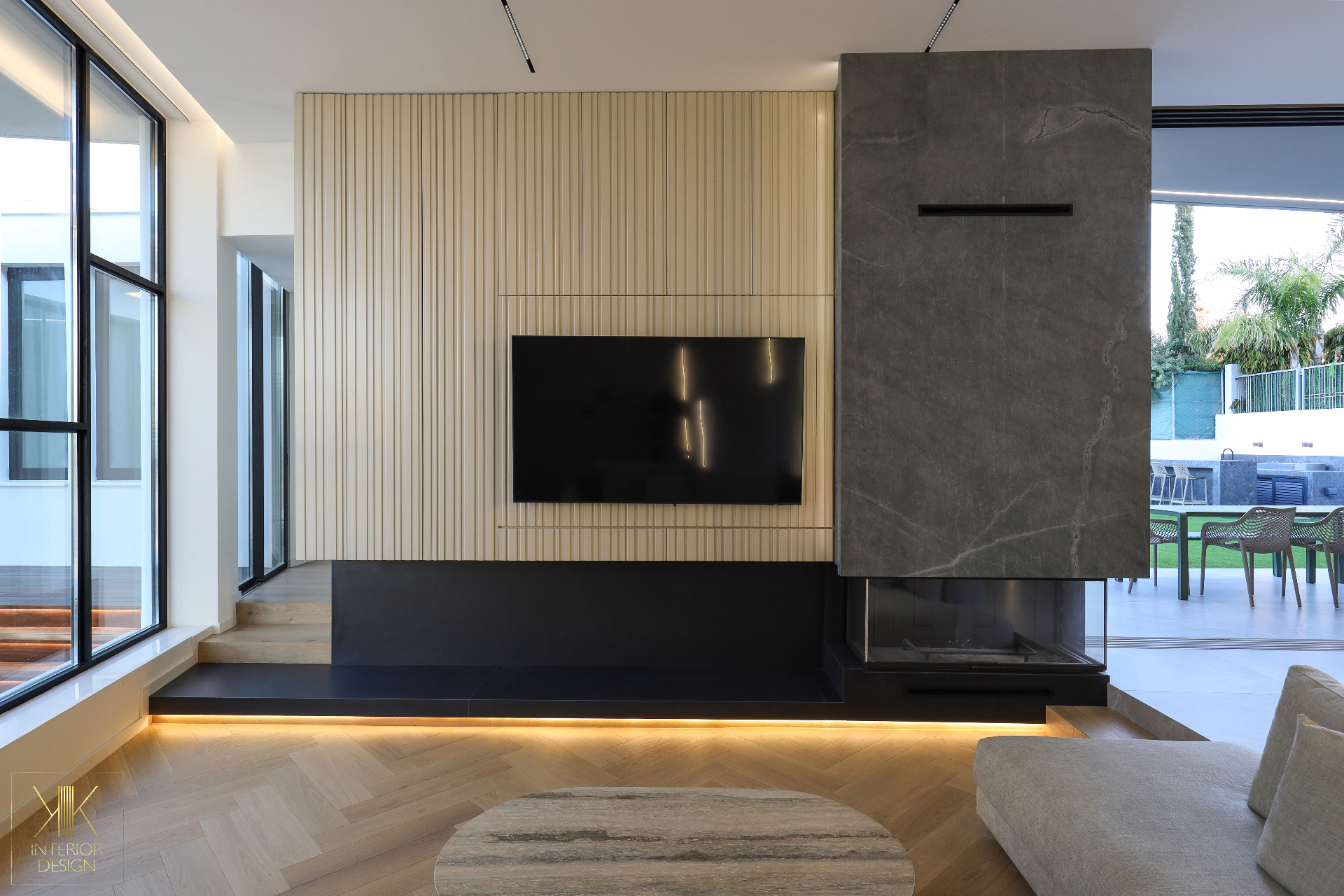 Fluted feature wall with integrated TV and stone fireplace