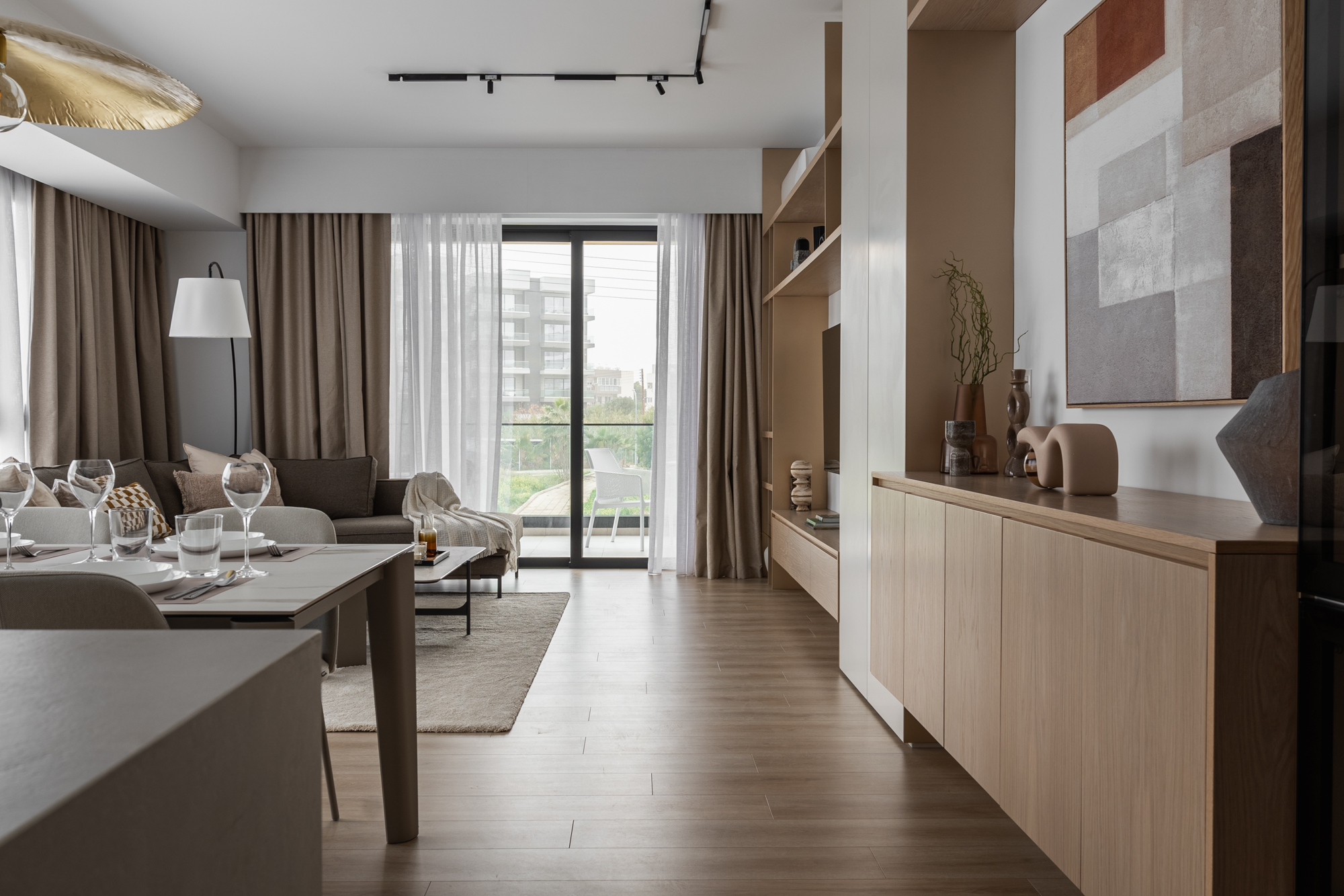 Open plan dining and living with oak sideboard and layered textiles