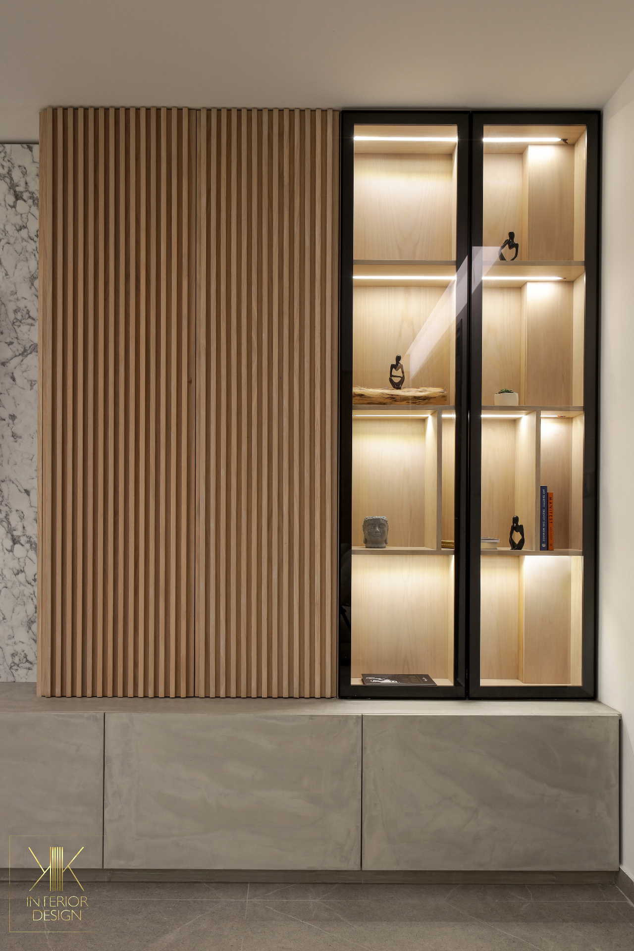Fluted oak cabinetry with backlit glass display and concrete console